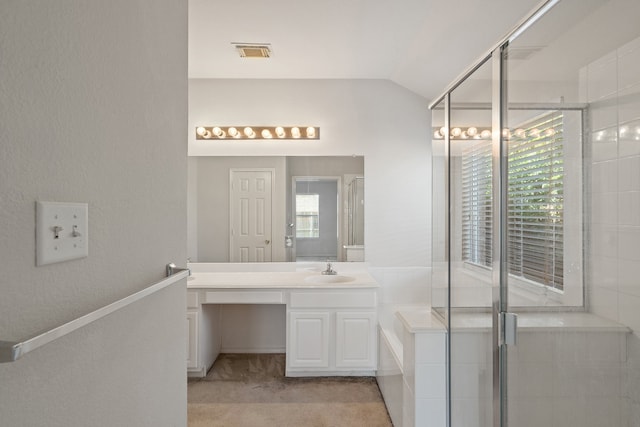 bathroom featuring vanity, lofted ceiling, and walk in shower