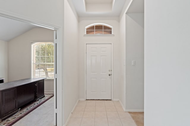 entrance foyer with lofted ceiling and light tile patterned floors