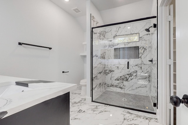 bathroom with a shower with door, vanity, and toilet