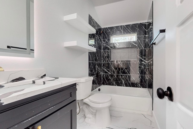 full bathroom with tiled shower / bath, vanity, and toilet