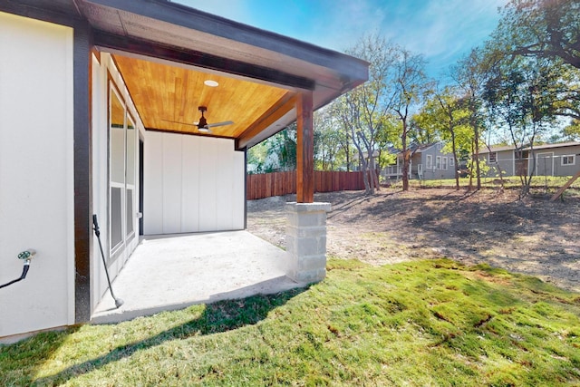 view of yard with ceiling fan and a patio area