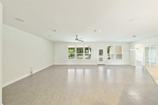 tiled spare room with ceiling fan