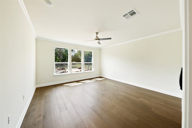 empty room with ceiling fan, crown molding, and dark wood-type flooring