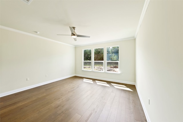 empty room featuring ceiling fan, ornamental molding, and hardwood / wood-style flooring