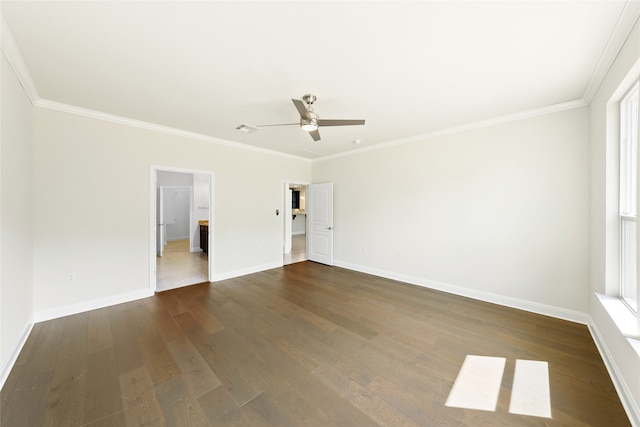 empty room featuring ceiling fan, crown molding, and dark wood-type flooring