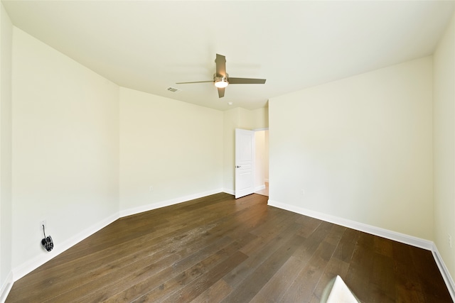 unfurnished room featuring ceiling fan and dark wood-type flooring