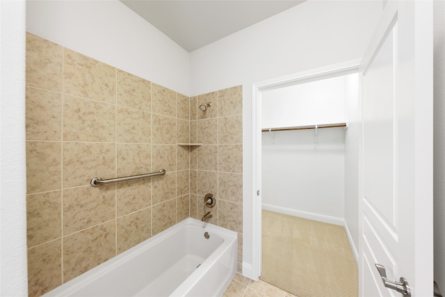 bathroom with tile patterned flooring and tiled shower / bath