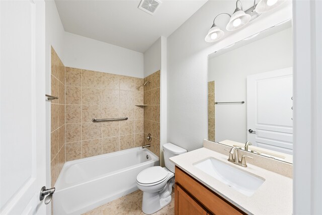 full bathroom with tiled shower / bath, vanity, and toilet