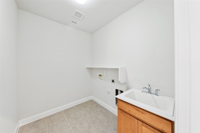 laundry area with electric dryer hookup, gas dryer hookup, sink, hookup for a washing machine, and light tile patterned floors