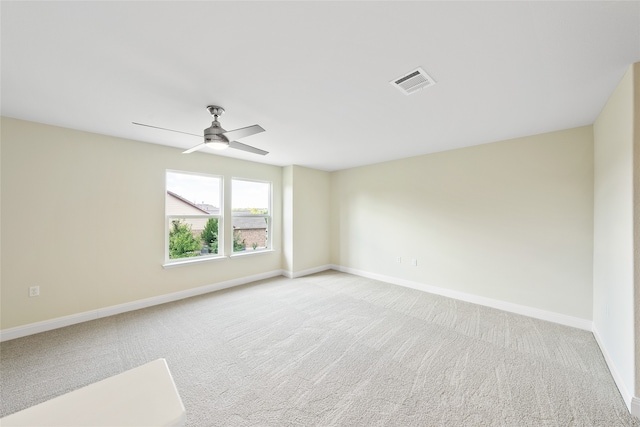 empty room featuring light carpet and ceiling fan