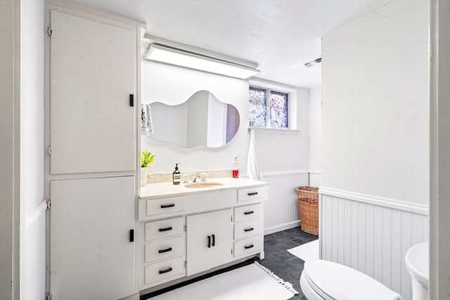 bathroom featuring vanity and toilet