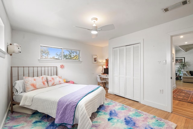 bedroom with a closet, ceiling fan, and light wood-type flooring