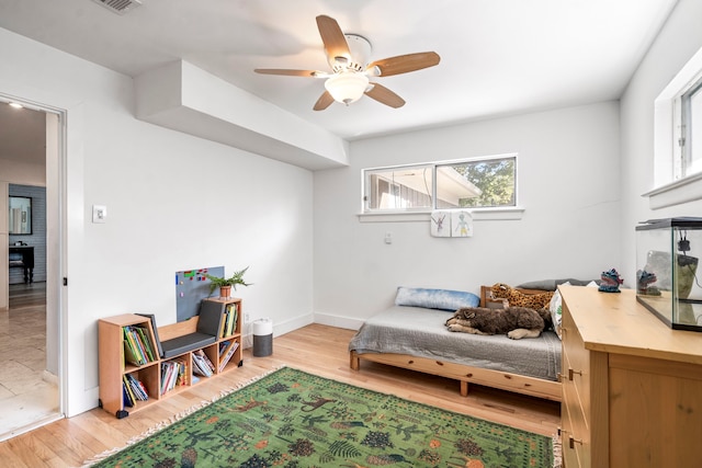 living area with ceiling fan, light hardwood / wood-style floors, and plenty of natural light