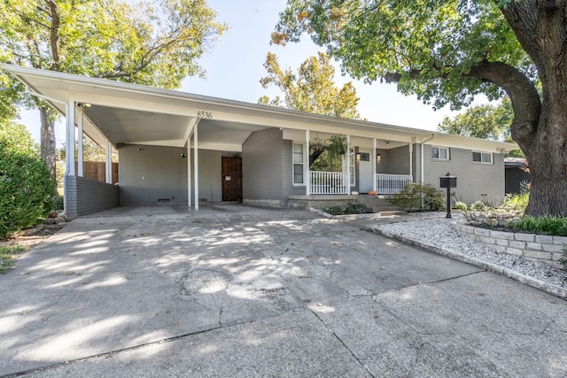 ranch-style house with a carport and a porch