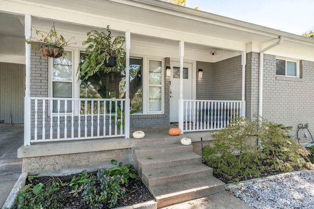 view of exterior entry with covered porch