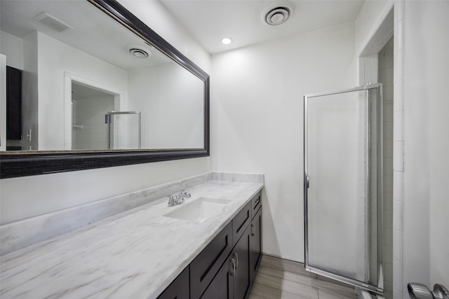 bathroom with vanity and walk in shower