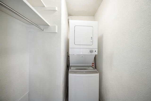 laundry room with stacked washer / dryer