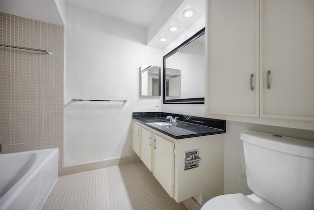 bathroom featuring tile patterned flooring, vanity, and toilet