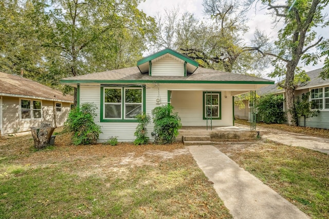 bungalow with a front yard and covered porch