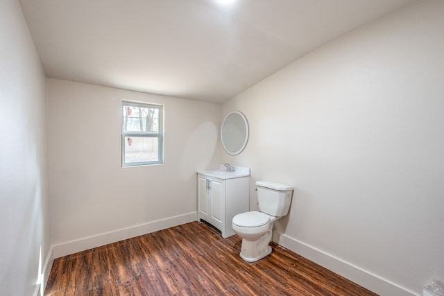 bathroom featuring vanity, hardwood / wood-style flooring, and toilet