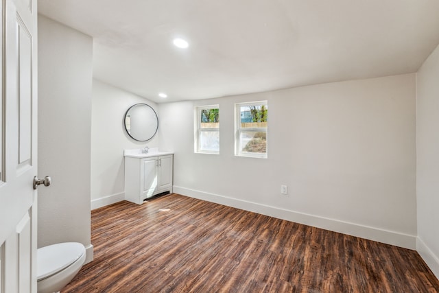 bathroom with vanity, toilet, and hardwood / wood-style flooring