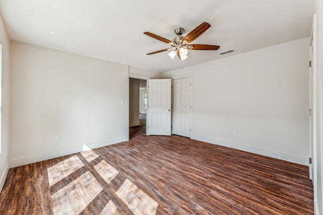 unfurnished room featuring dark hardwood / wood-style floors and ceiling fan