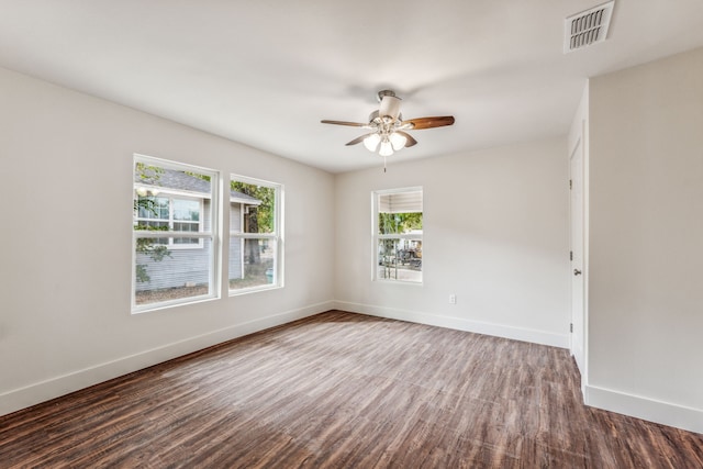 empty room featuring ceiling fan and dark hardwood / wood-style floors