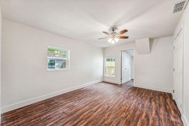 unfurnished bedroom featuring ceiling fan and dark hardwood / wood-style flooring