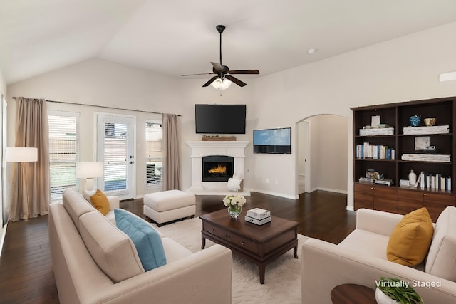 living room with lofted ceiling, wood-type flooring, and ceiling fan