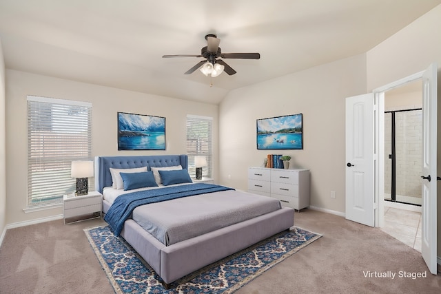 carpeted bedroom featuring ensuite bath and ceiling fan