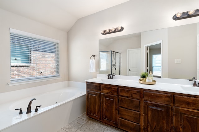 bathroom featuring vanity, a healthy amount of sunlight, independent shower and bath, and vaulted ceiling