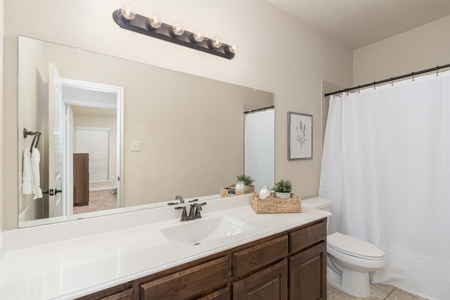 bathroom with vanity, toilet, and tile patterned flooring