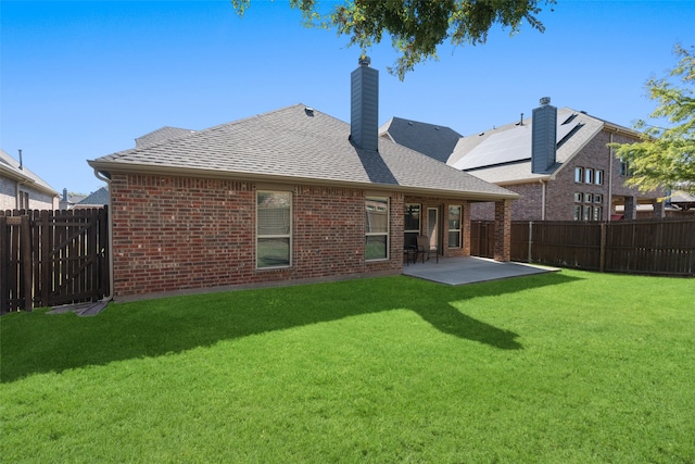 back of house featuring a yard and a patio