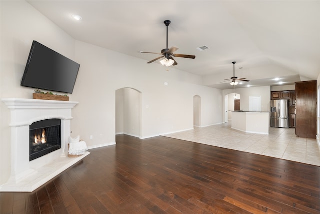 unfurnished living room featuring ceiling fan and light hardwood / wood-style flooring