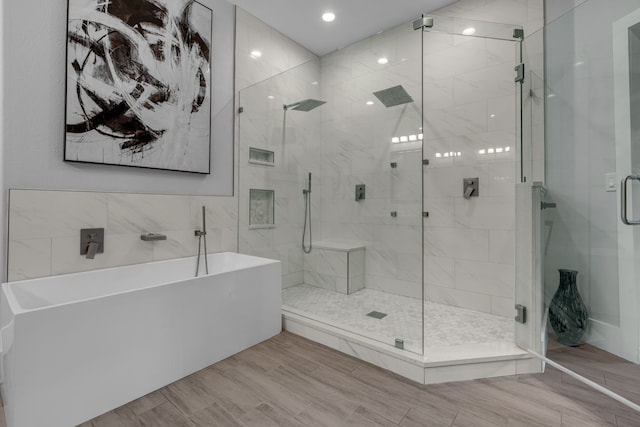 bathroom featuring independent shower and bath and hardwood / wood-style floors