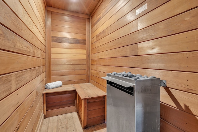 view of sauna / steam room with wood ceiling, wood walls, and hardwood / wood-style floors