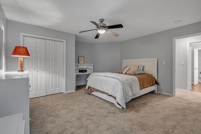 bedroom featuring light carpet, a closet, and ceiling fan