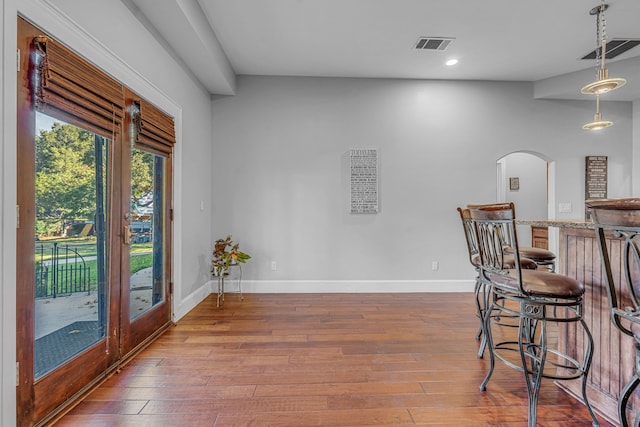 dining room with bar and hardwood / wood-style floors