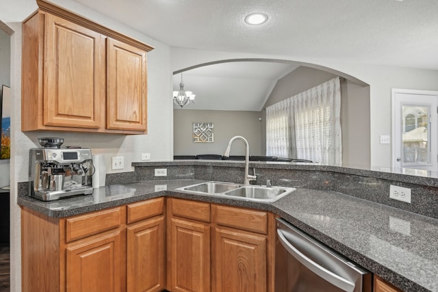 kitchen featuring sink, dishwasher, a textured ceiling, vaulted ceiling, and a notable chandelier