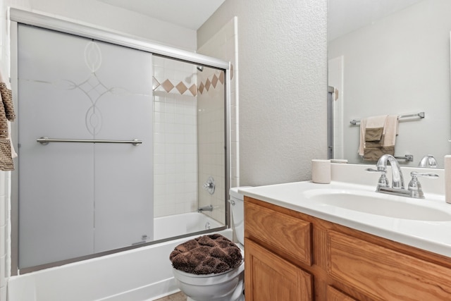 full bathroom featuring vanity, enclosed tub / shower combo, and toilet