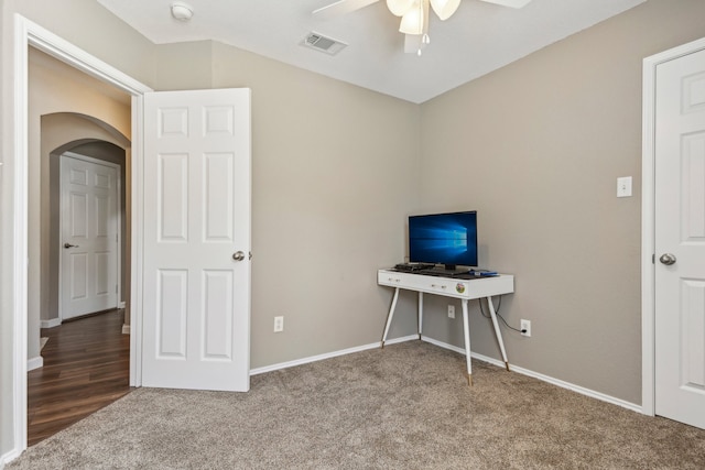 unfurnished office featuring carpet floors and ceiling fan