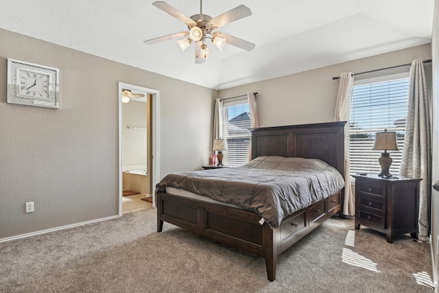 bedroom with multiple windows, ensuite bath, carpet, and ceiling fan