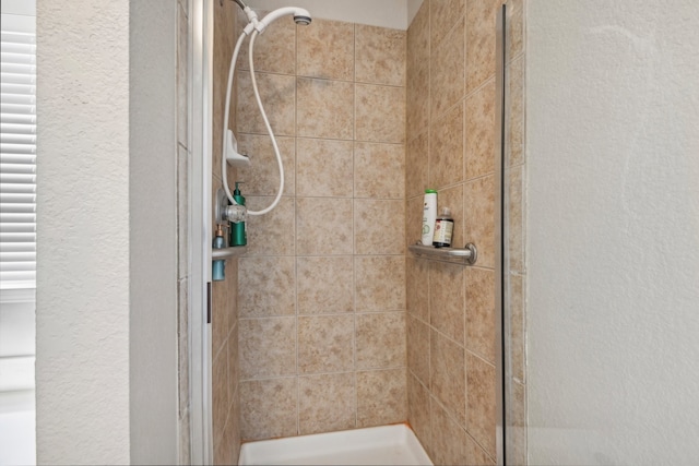 bathroom with a shower with shower door