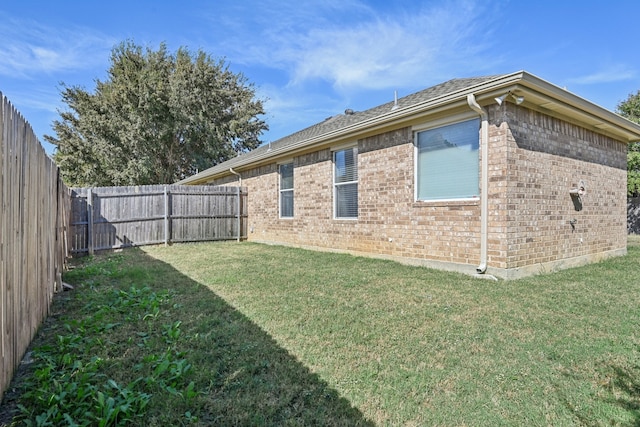 view of side of home with a lawn