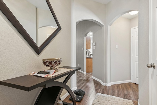 812 Redbud Rd, Burleson, TX 76028 - corridor featuring arched walkways, wood finished floors, and baseboards