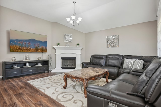 living room featuring dark wood-type flooring, vaulted ceiling, and an inviting chandelier