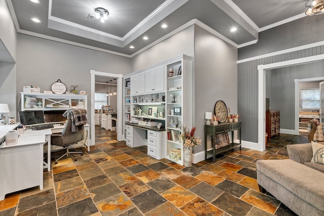 office space with built in desk, ornamental molding, and a high ceiling