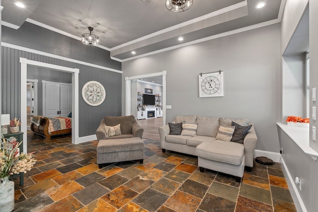 living room with an inviting chandelier and ornamental molding