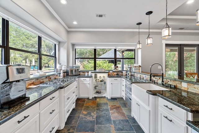 kitchen featuring dark stone counters and plenty of natural light