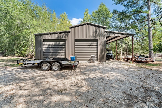 view of outbuilding featuring a garage and a carport